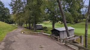 Rustic covered corn crib bridges and cart path on hole 11 at EagleSticks Golf Club
