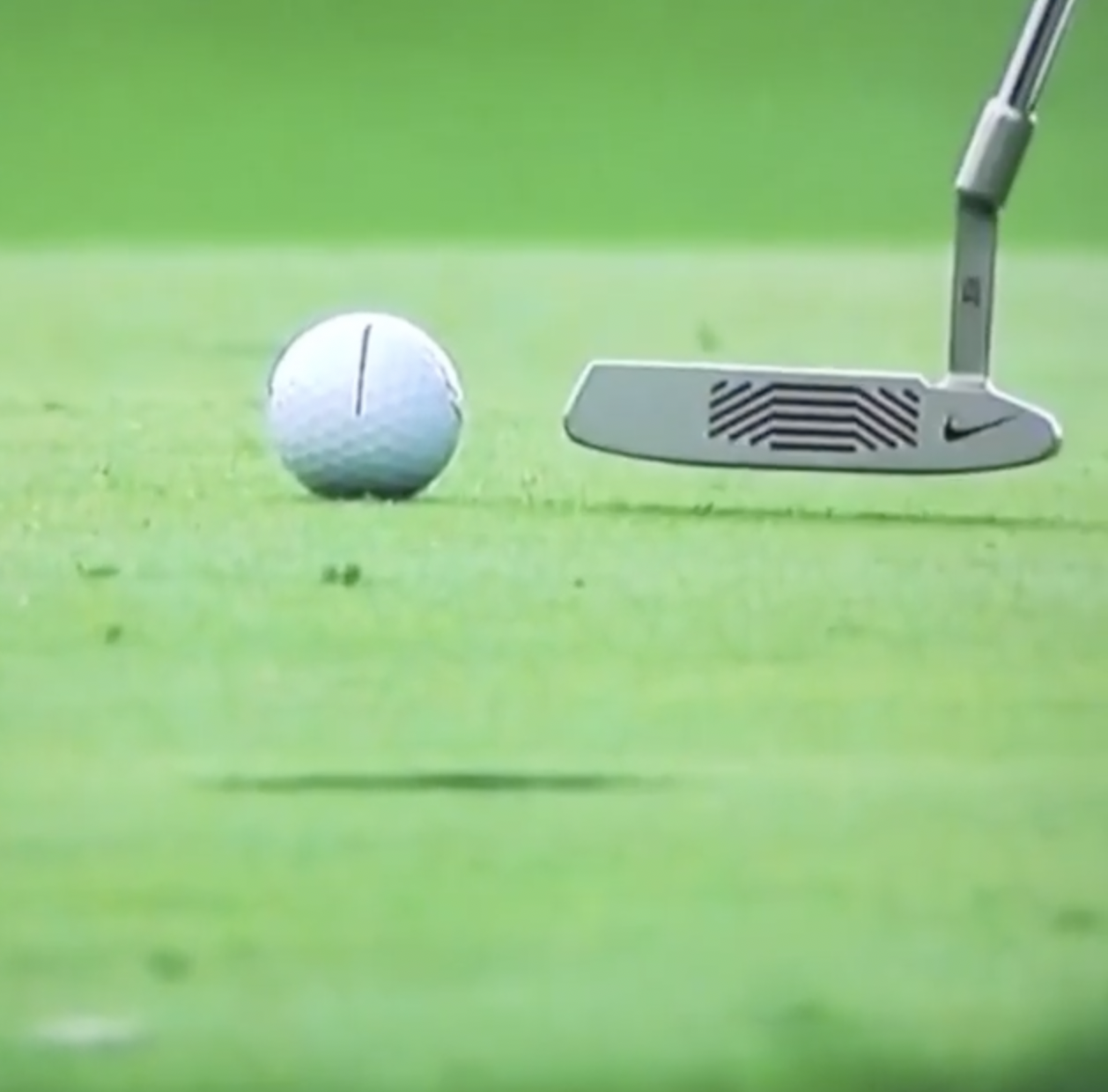 Golfer practicing putting speed control