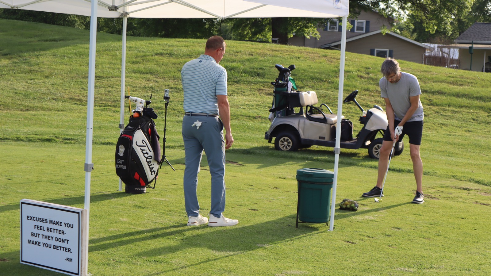 Kelly Morrow giving a golf lesson at the EagleSticks driving range