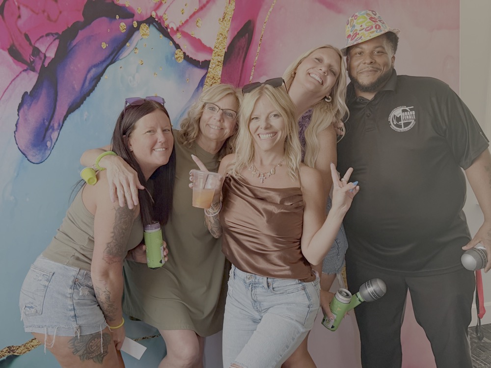 Ladies posing with the DJ at Ladies Who Brunch